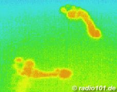 Thermographic picture - infrared photograph: warm foot prints on cold stone tiles, still visible after minutes