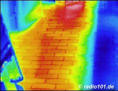 Thermographic picture - infrared photograph: hot tiles on a balcony in the summertime, partially shadowed
